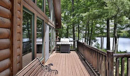 a porch of a house with a bench on the side at The Hideaway on Clear Lake Island in Hayward