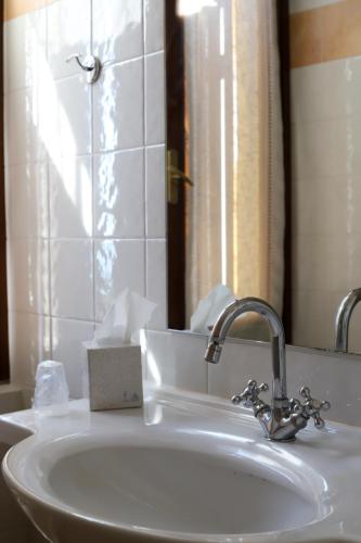 a bathroom with a sink and a mirror at San Rocco Relais in Soiano del Lago