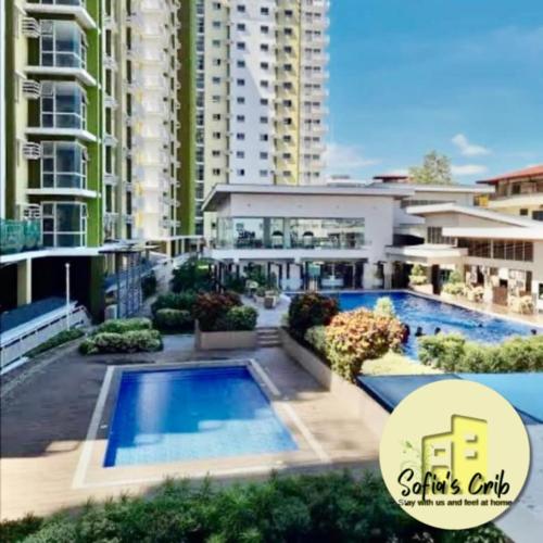 a large apartment building with a large swimming pool at Sofia's Crib Mesaverte Garden Residences in Cagayan de Oro
