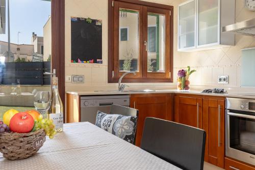a kitchen with a table with a bowl of fruit on it at Townhouse Ses Passadores in Porreres