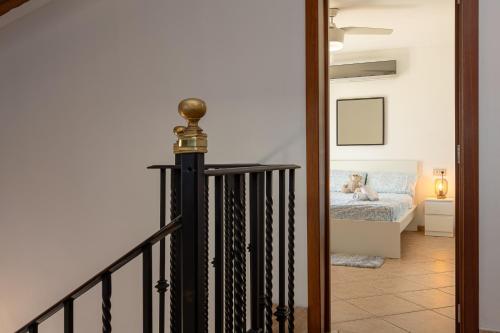 a staircase leading to a bedroom with a teddy bear on a bed at Townhouse Ses Passadores in Porreres