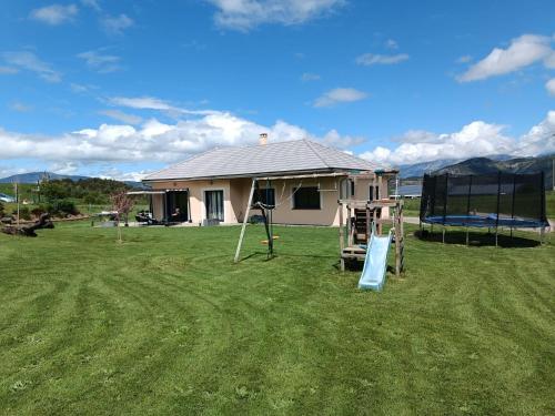 a house in a yard with a playground at Magnifique Villa Sabot de Venus in Le Lautaret