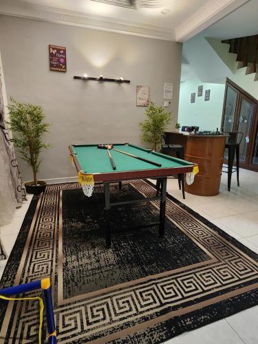 a pool table on a rug in a room at Galaxy Guest Home by Ipoh Maju Stay in Ipoh