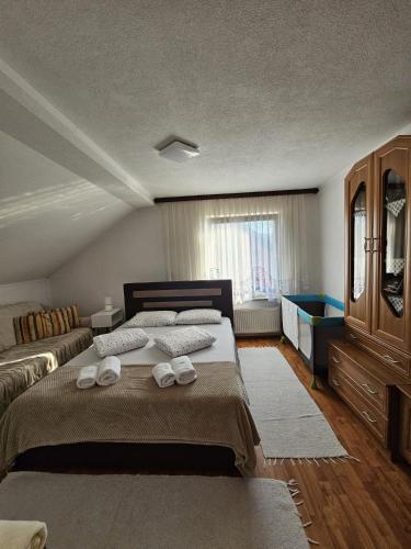 a bedroom with a bed with two towels on it at Holiday Home Peaceful Retreat in Visoko