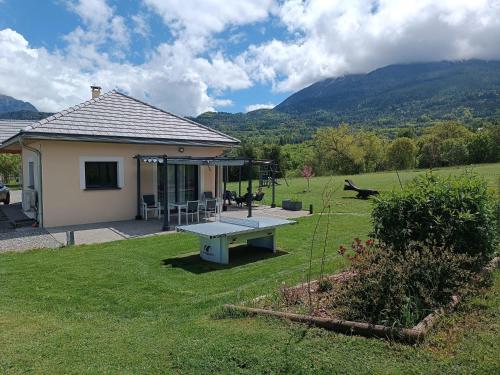 a house with a picnic table in a yard at Magnifique Villa Sabot de Venus in Le Lautaret