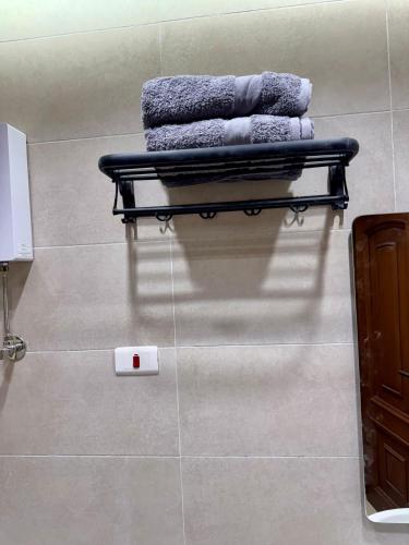 a bench in a bathroom with towels on the floor at ALEX HOMES - Gleem Luxury Apartments with Direct Sea View in Alexandria