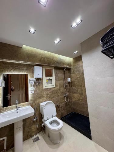 a bathroom with a toilet and a sink and a shower at ALEX HOMES - Gleem Luxury Apartments with Direct Sea View in Alexandria
