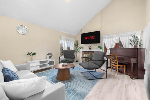 a living room with a couch and a piano at Mira Mesa Family Retreat 4BR with Balcony and Firepit in San Diego
