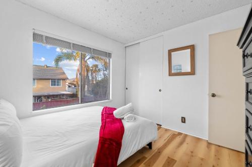 a bedroom with a bed and a large window at Mira Mesa Family Retreat 4BR with Balcony and Firepit in San Diego