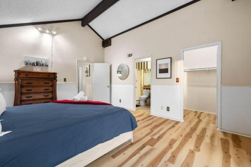 a bedroom with a blue bed and a wooden floor at Mira Mesa Family Retreat 4BR with Balcony and Firepit in San Diego