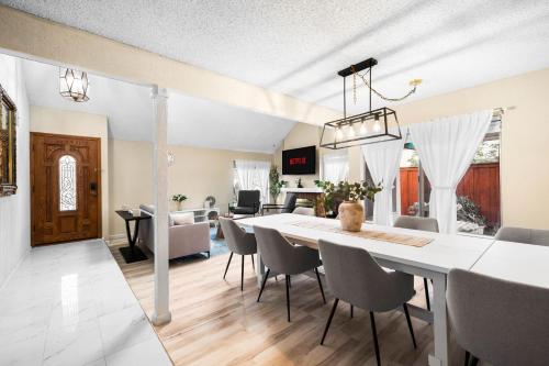a dining room and living room with a table and chairs at Mira Mesa Family Retreat 4BR with Balcony and Firepit in San Diego