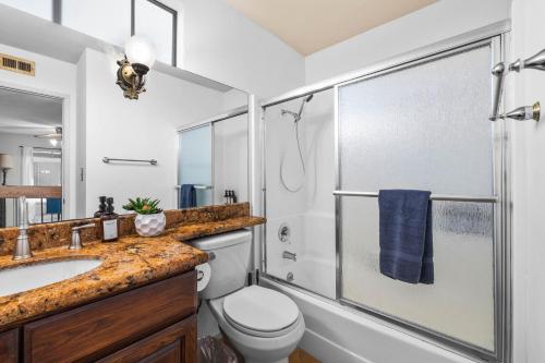 a bathroom with a shower and a toilet and a sink at Mira Mesa Family Retreat 4BR with Balcony and Firepit in San Diego