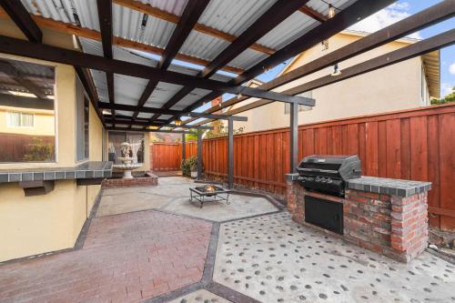 a patio with awning and a grill on a house at Mira Mesa Family Retreat 4BR with Balcony and Firepit in San Diego