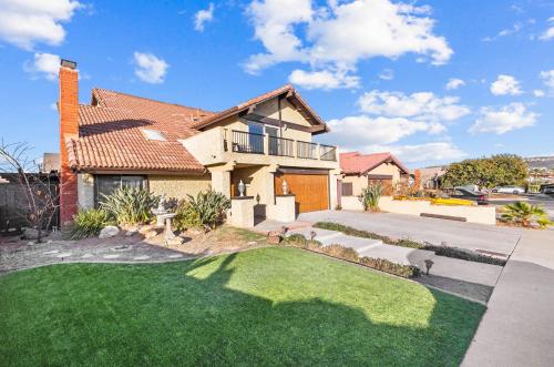 a house with a green lawn in front of it at Mira Mesa Family Retreat 4BR with Balcony and Firepit in San Diego