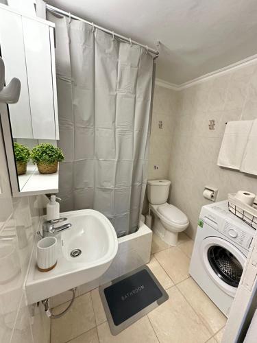 a bathroom with a sink and a washing machine at Seaside escape in Symi