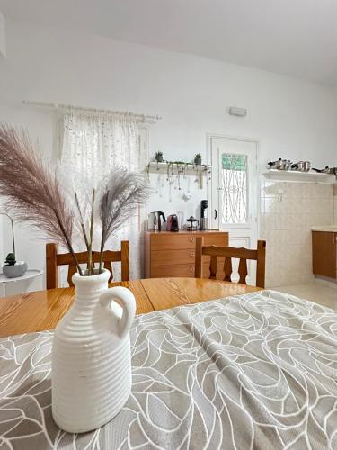 a white vase sitting on a table in a living room at Seaside escape in Symi
