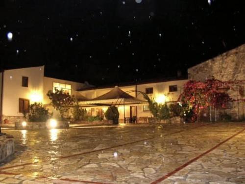 a building at night with rain on the ground at Agriturismo Santa Venera in Polizzi Generosa