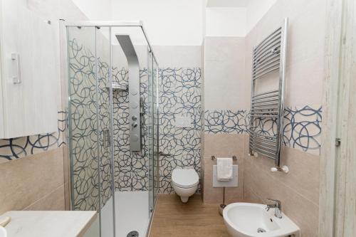 a bathroom with a shower and a toilet and a sink at B&B Villa Noemi in Porto Cesareo