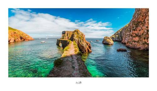 a view of the ocean with rocks in the water at Residência Maciel in Peniche