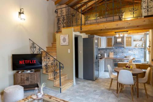 a living room with a kitchen and a dining room at Strofilia House Near ATH Airport in Markopoulo