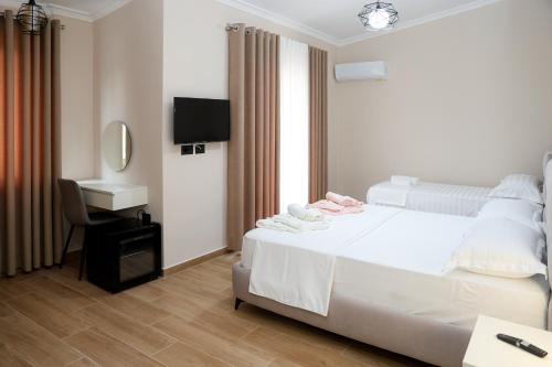 Postel nebo postele na pokoji v ubytování Saliasi hotel&apartament