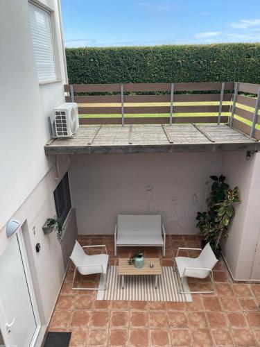 a small patio with a table and chairs on a balcony at Marion Apartments in Kourouta