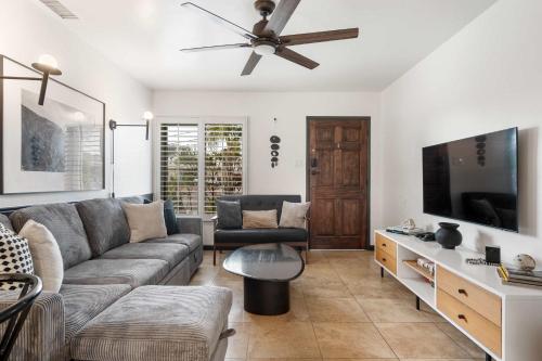 a living room with a couch and a flat screen tv at San Diego Chill House with Jacuzzi-Golf-Game Room in San Diego