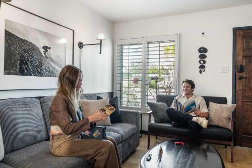 a man and a woman sitting in a living room at San Diego Chill House with Jacuzzi-Golf-Game Room in San Diego