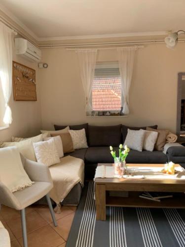 a living room with a couch and a table at Pusztavár-Lak in Erdőhorváti