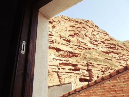 a building with a stone wall next to a door at Albergue Nido de Cigüeña in Nájera