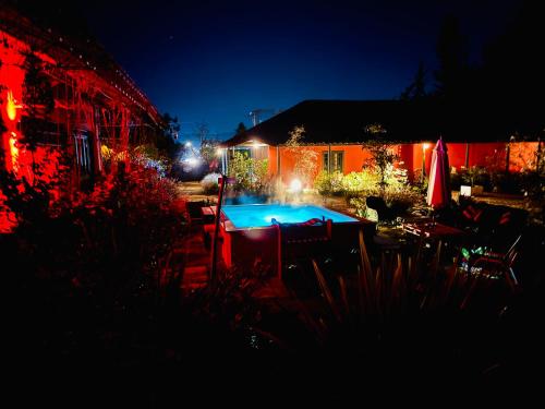 a backyard with a swimming pool at night at The White House by Casona Lo Aguirre - El Monte RM in Talagante