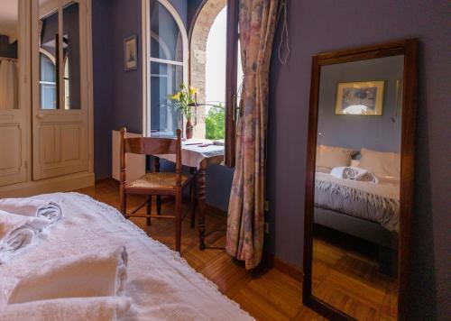 a bedroom with a mirror and a bed and a table at Lacoume Saint Jacques in Auch