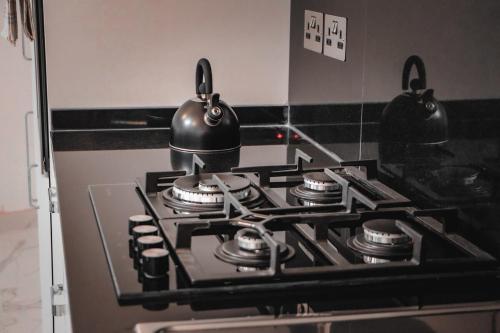 a stove with pots and pans on top of it at Beachfront Apartment 1 in St Paul's Bay