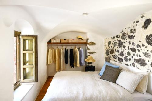 a bedroom with a bed and a window at Santorini Vista Legacy Retreat - Live the history, wake to the view in Pirgos