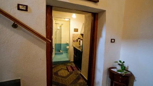 a hallway with a bathroom with a shower and a sink at The Home of Diplomacy in Gjirokastër