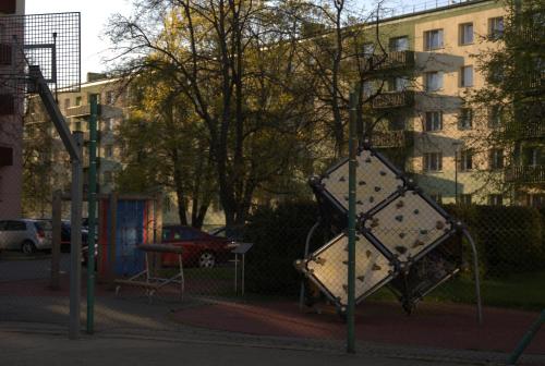 a playground in a city with a swing at Cozy Retreat Apartment in Ventspils