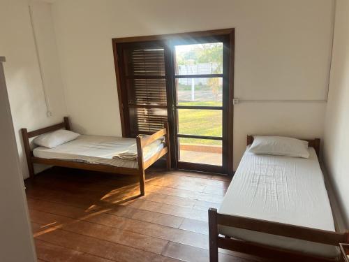 Ένα ή περισσότερα κρεβάτια σε δωμάτιο στο Hostel do Cabral