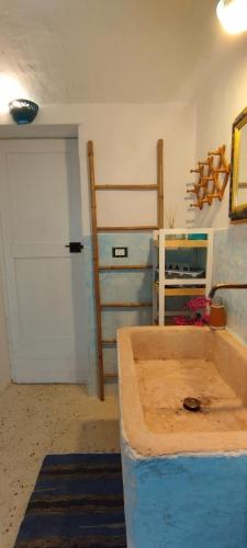 a room with a garage with a door and a bed at Dimora Maltese in Morciano di Leuca