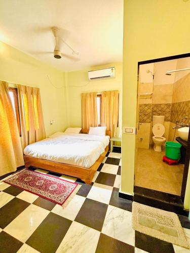 a bedroom with a bed and a checkered floor at Narayana's Haveli in Varanasi