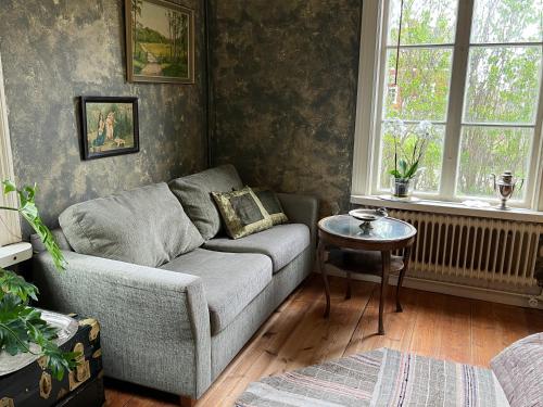 a living room with a couch and a table at Norrgården Hälsingland in Vallsta