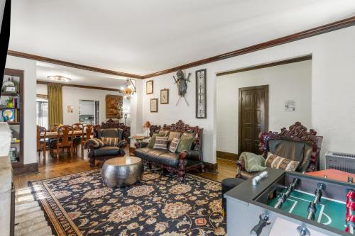a living room filled with furniture and a pool table at Tulsa Gathering Place Castle-a Good Knight's Rest in Tulsa