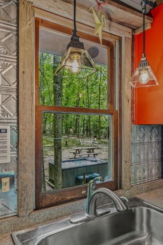 a kitchen with a window with a view of a picnic table at River Walk Cottage - Romantic Escape in Great Cacapon