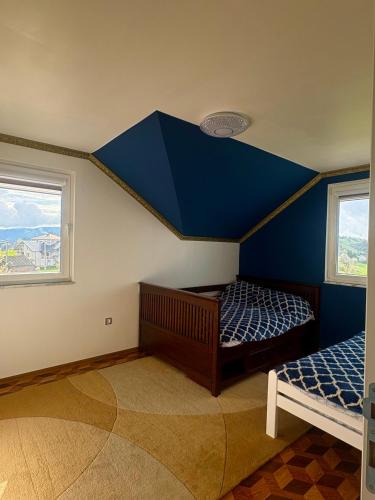a room with two beds and a blue ceiling at Aqua Verde Sarajevo in Nišići