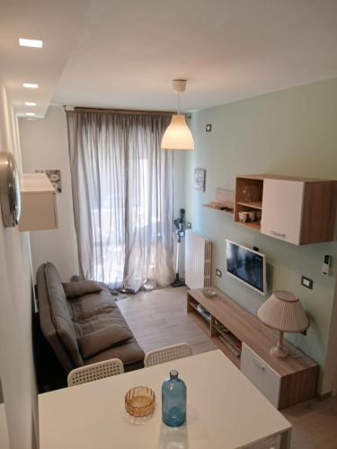 a living room with a couch and a table at Sole e mare in Porto SantʼElpidio