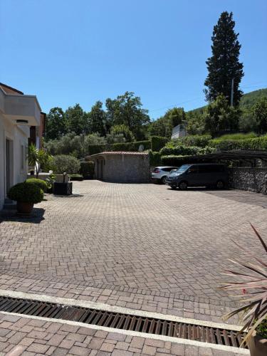a parking lot with cars parked in a driveway at Bed and Breakfast Villa Iris in Mošćenička Draga