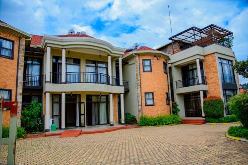 a large brick house on a brick driveway at Quality Inn Hotel Kigali in Kigali