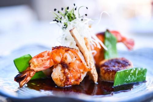 a plate of food with shrimp and rice at The Westin Resort, Costa Navarino in Romanós