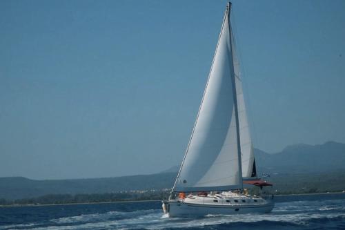 a sailboat on the water with a blue sky at The Westin Resort, Costa Navarino in Romanós