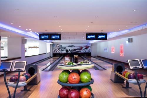 a bowling alley with pins and apples on display at The Westin Resort, Costa Navarino in Romanós