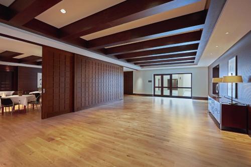 a large room with wooden ceilings and a dining room at The Westin Resort, Costa Navarino in Romanós
